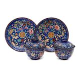 A pair of Chinese Canton enamel bowls with covers and stands, early 19th century, each painted