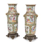 A pair of Chinese Canton vases, late 19th century, painted in famille rose enamels with panels of