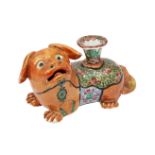 A Chinese porcelain lion dog taper-stick holder, late Qing dynasty, painted in famille rose