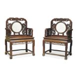 A pair of Chinese hardwood armchairs, 19th century, the carved backs set with circular marble