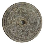 A large Chinese bronze Tang style circular mirror, 20th century, cast with deities and mythical