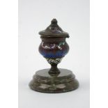 An bronze & enamelled inkwell, 19th century, of urn form with a hinged lid, on a fossil marble