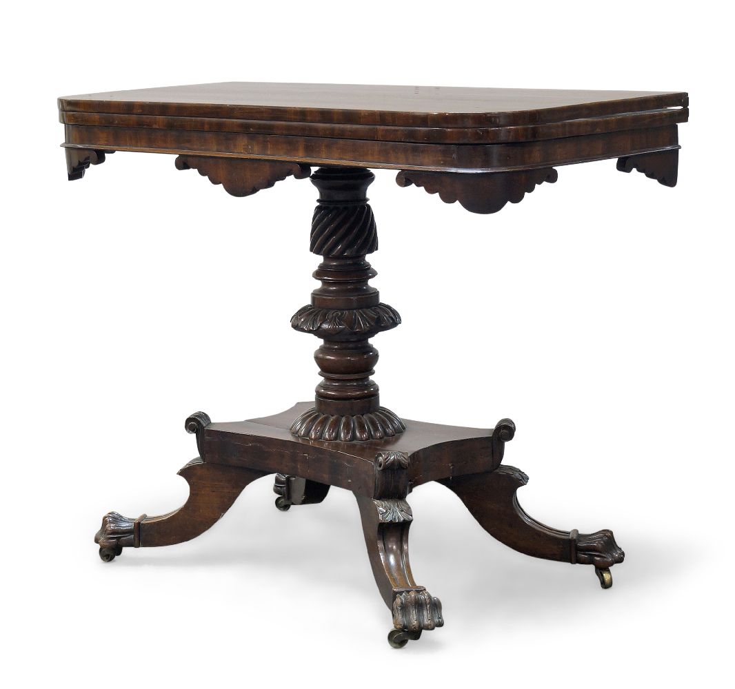 A Victorian mahogany tea table, the shaped fold over top, above turned and carved column to