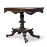 A Victorian mahogany tea table, the shaped fold over top, above turned and carved column to