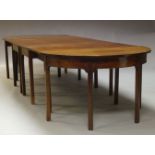 A George III and later mahogany D-end dining table, the rounded rectangular top with two later D-
