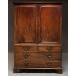 A mahogany linen press, 19th Century, with dentil moulded cornice above two panelled doors enclosing