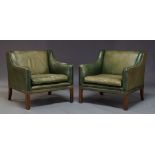 A pair of green leather armchairs, mid 20th Century, the square backs with down swept arms and brass