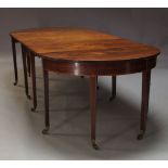 A George III and later mahogany extending dining table, with two D-ends flanking drop leaf central