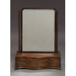 A George III mahogany swing frame dressing table mirror, of arched form, with square finialed