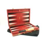 A Dunhill backgammon set, the red rectangular cased designed with black and white point triangles,