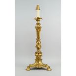 A gilt bronze oil lamp base , 19th century, moulded with scrolling foliage, on a triangular base,