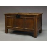 An oak coffer, 18th Century and later, the hinged lid enclosing storage space and candle box, with
