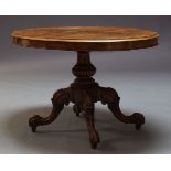 A Victorian walnut loo table, the oval quarter veneered top on carved baluster form support, to four