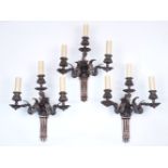 A group of three 19th century copper three branch wall lights, each with two lights raised on