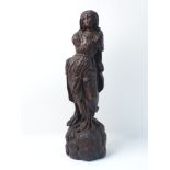 A North European wood carving, 16th century, designed as standing woman in drapery to a naturalistic