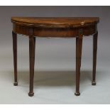 A George III mahogany card table, the semi-circular fold-over top and moulded frieze on stop