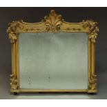 An Victorian giltwood overmantle mirror, with carved scrolling foliate decoration to frame about a