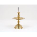 A colonial Dutch brass 'Heemskerk' candlestick, 17th century, with a knopped stem, domed base and