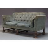 A Victorian button back sofa, upholstered in blue velvet with four loose cushions, on ring turned