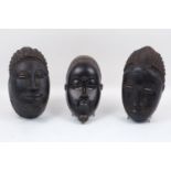 A group of three Baule masks, late 20th century, each of typical composition, largest 30cm long (3)