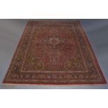 A Kashan carpet, with indigo pole medallion in deep red field with over all foliate design and