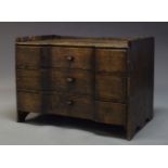 A Continental provincial stained pine chest, 18th Century and later, of inverse breakfront form,