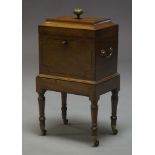 A Regency mahogany and ebony strung wine cooler, of sarcophagus form, the lid surmount with brass