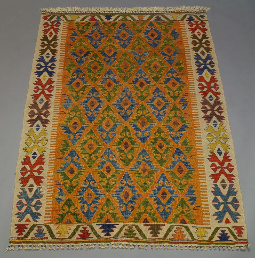 An Anatolian Kilim, the polychrome field with six hexagonal lozenge medallions and all over - Image 2 of 3