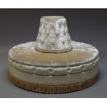 A circular conversation sofa, late 20th Century, with buttoned fawn velvet upholstery, with tassel