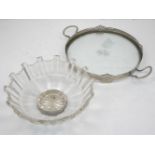 A pewter mounted glass tray, of circular form, with two handles and a raised rim with pierced