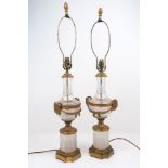 A pair of early 20th century glass and brass table lamps, with ram's head and swag fittings to the