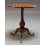 A Victorian walnut games table, the octagonal top inlaid with chessboard, on baluster form