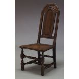 An oak side chair, 17th Century and later, the shaped, moulded and pierced backrest, above plank