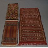 An Anatolian Kilim rug, with rows of geometric motifs, together with two kilim mats and two
