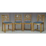A set of four Cotswold school oak dining chairs, with lattice backs, above blue leather drop in