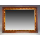 A mahogany and marquetry inlaid overmantle mirror, late 19th Century, the rectangular plate set