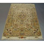 A part silk Tabriz rug, late 20th Century, having central foliate medallion in ivory field, with