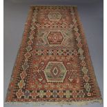 An Anatolian Kilim, with three hexagonal medallions and repeat geometric design border, 343cm x