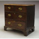 A George III mahogany chest, with two short over two long graduated drawers, raised on shaped