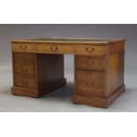 An Edwardian oak partner's desk, the rectangular top inset with later writing surface, above an