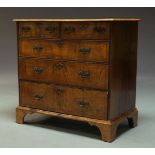 A George II and later walnut and crossbanded chest, with two short over three long drawers, raised