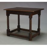 An oak side table, the rectangular top above frieze decorated with carved floral lunettes, on turned