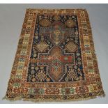 A Kazak rug, with two cruciform medallions in indigo field, with ivory main border, 175cm x