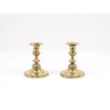 A pair of French brass candlesticks, 18th century, each cylindrical socket with rope twist