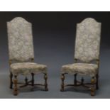 A pair of 17th Century style walnut high back chairs, mid 20th Century, with floral needlework