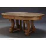 An oak extending dining table, second half 20th Century, the rounded rectangular top with two