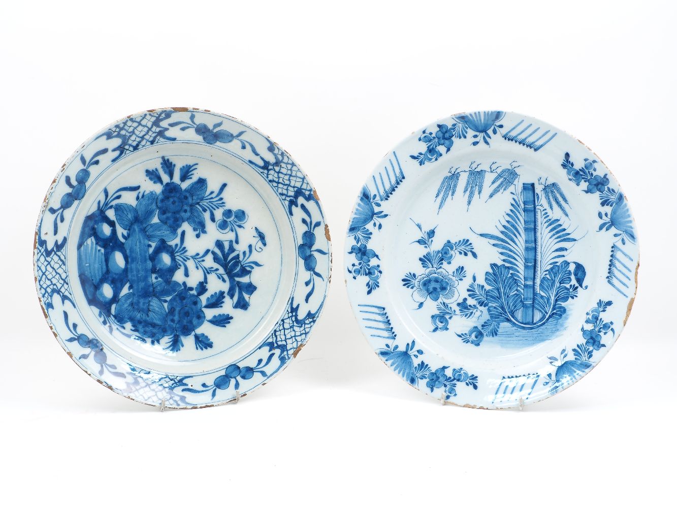 An 18th century Dutch Delft Ware charger, decorated in blue and white stylised naturalistic forms,