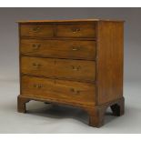 A George III mahogany chest with two short over three long graduated drawers, raised on bracket