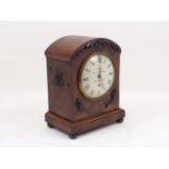 A Victorian mahogany bracket clock, the white enamel dial with black Roman numerals, black batons,