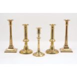 A pair of English brass candlesticks, 18th century, with plain polished sockets, square form drip